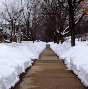 Sidewalk with snowbanks along the sides