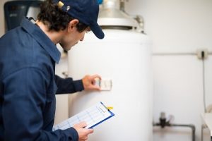 Plumber installing a water heater