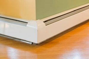 Baseboard heating system along a wall