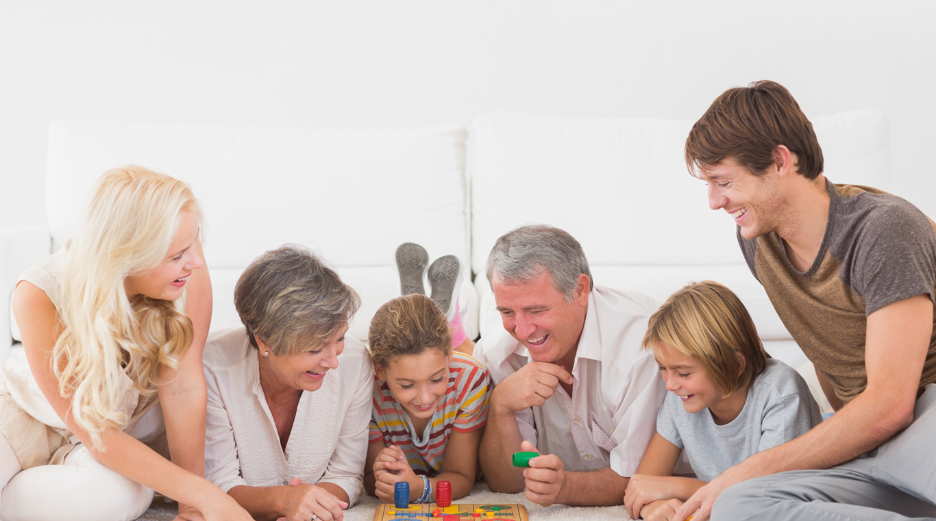 family laying on floor playing game