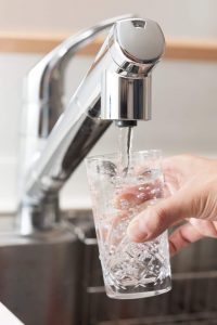 Filtered water pouring from kitchen faucet