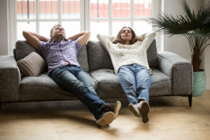 Couple relaxing at home on the couch