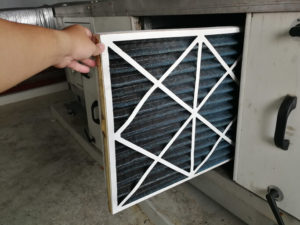 Homeowner changing their HVAC filter
