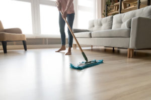 Person mopping a hardwood floor