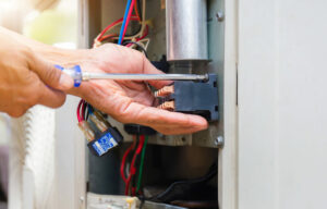 Technician repairing a heat pump