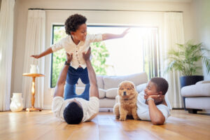 Shot of a happy family relaxing together with their pet dog in the lounge at home